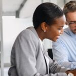 Two business people discussing the changes in the venture growth market.