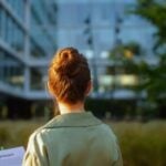 woman stood infront of modern business that incorporates ESG criteria