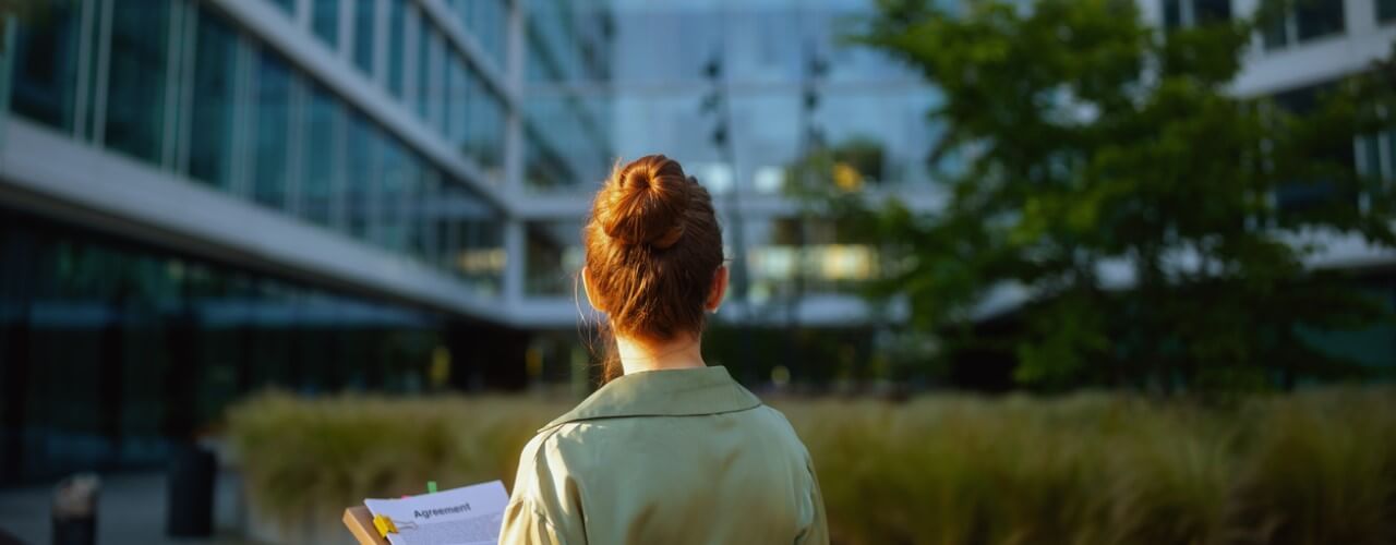 woman stood infront of modern business that incorporates ESG criteria